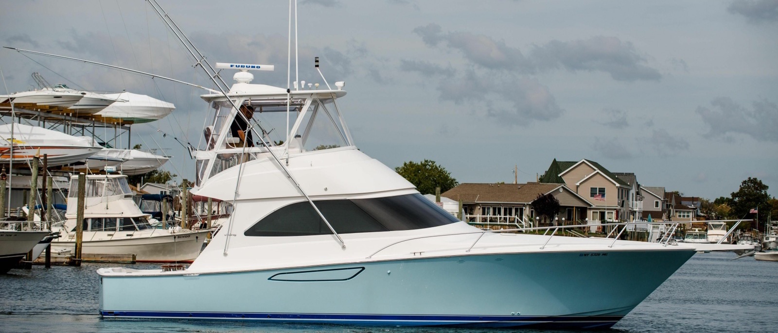 A 42-foot sportfisher motoring past a marina