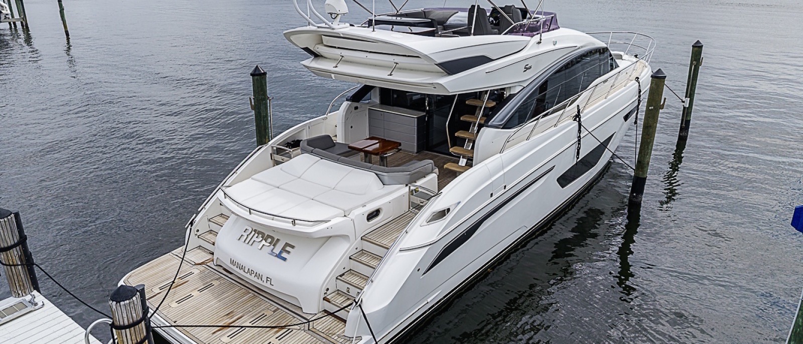 Aerial view of a 65-foot yacht at a waterfront dock
