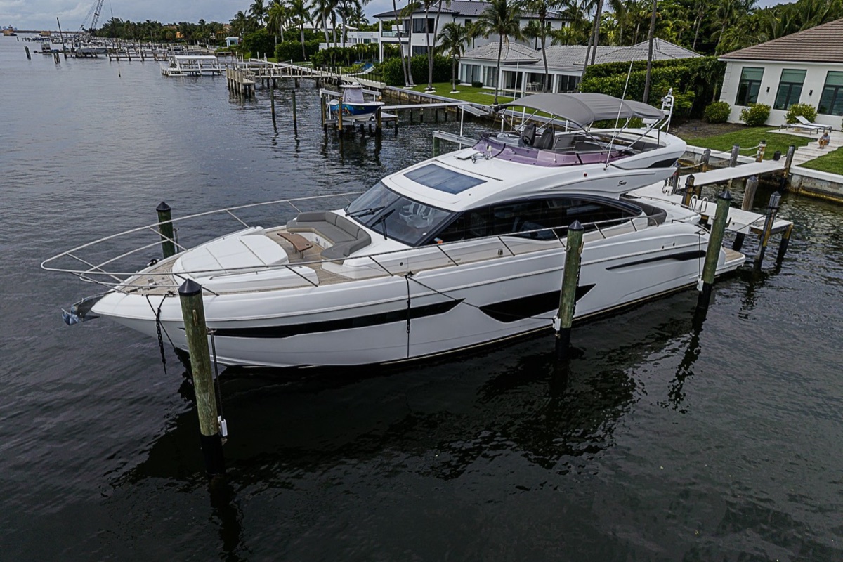 A 65-foot flybridge motor yacht moored at a private dock