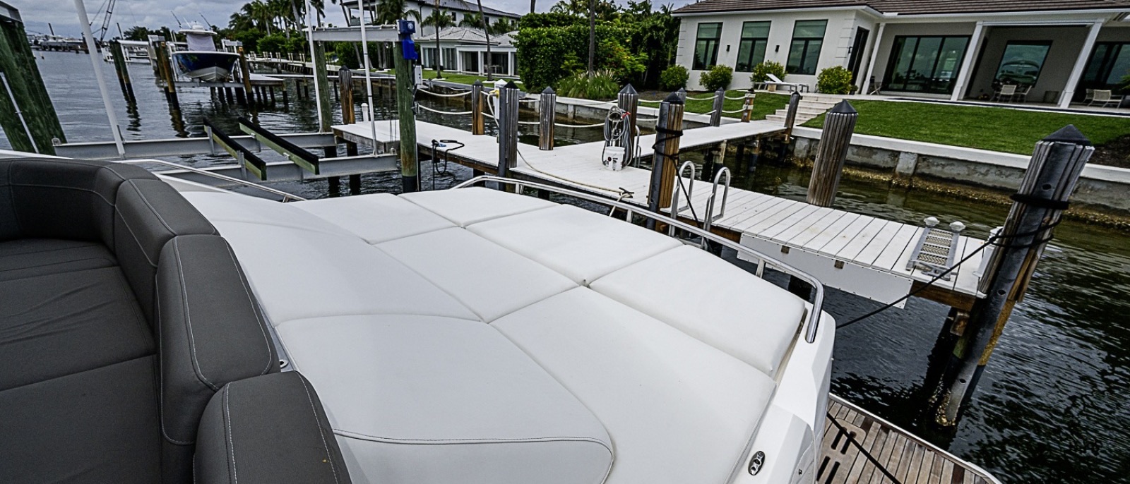 The foredeck sun pad of a 65-foot yacht moored at a private dock