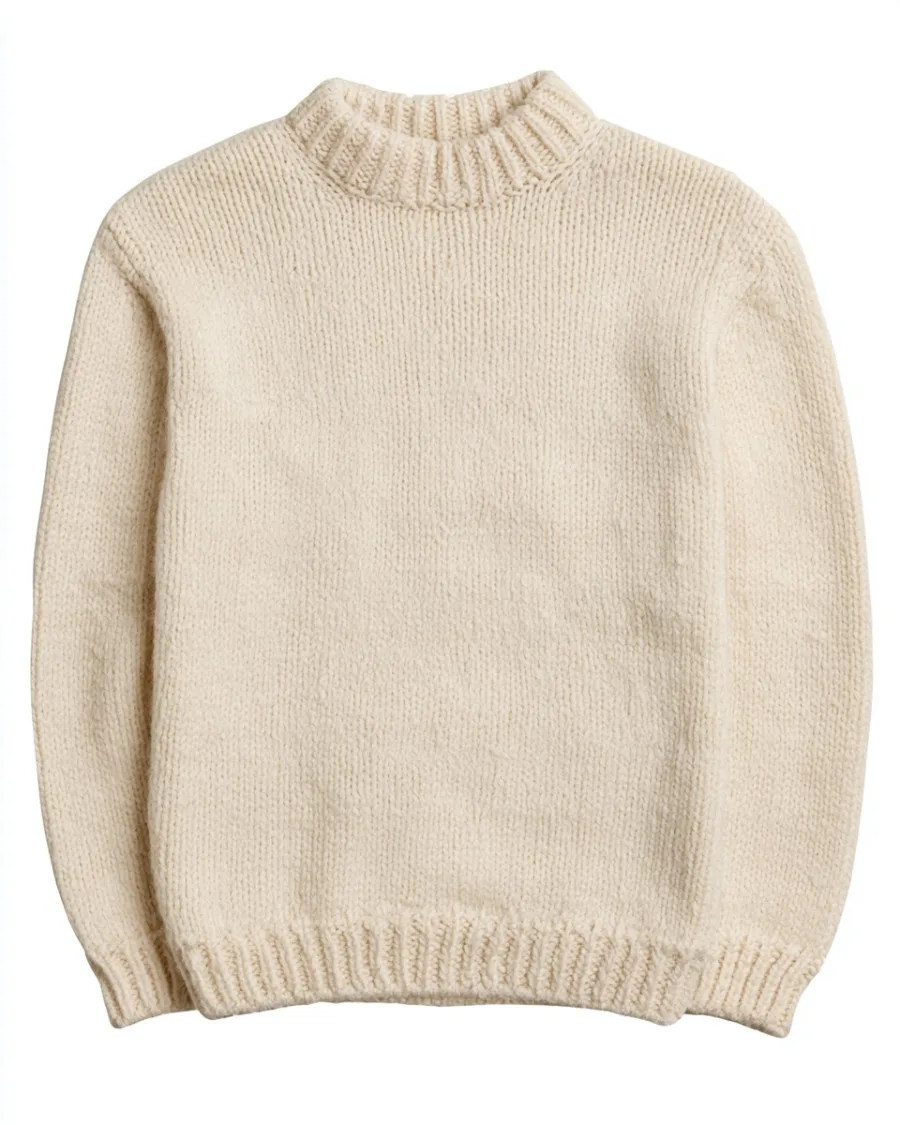 Folded ecru lambswool jumper isolated on white