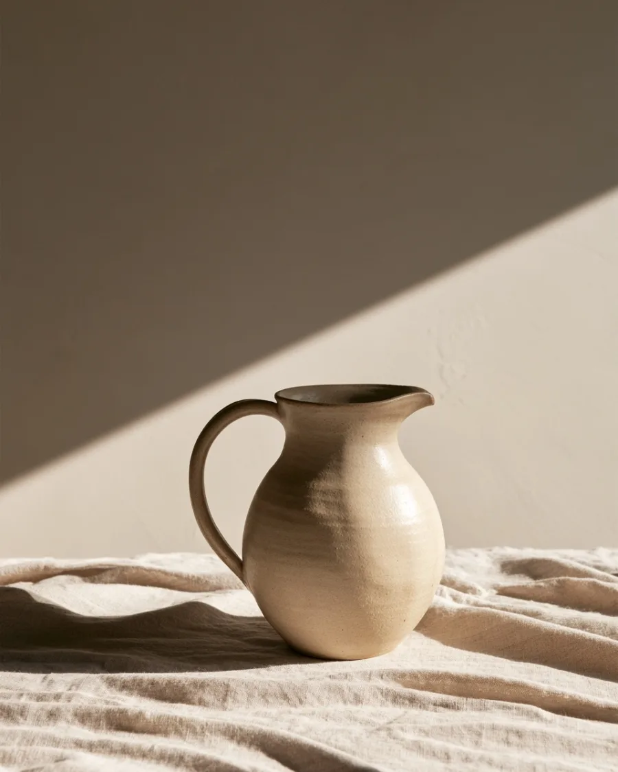 Pale clay jug with a pinched spout, side on