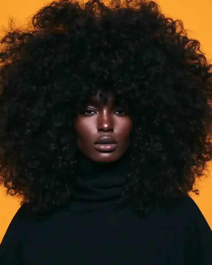 Full round afro against a saffron backdrop