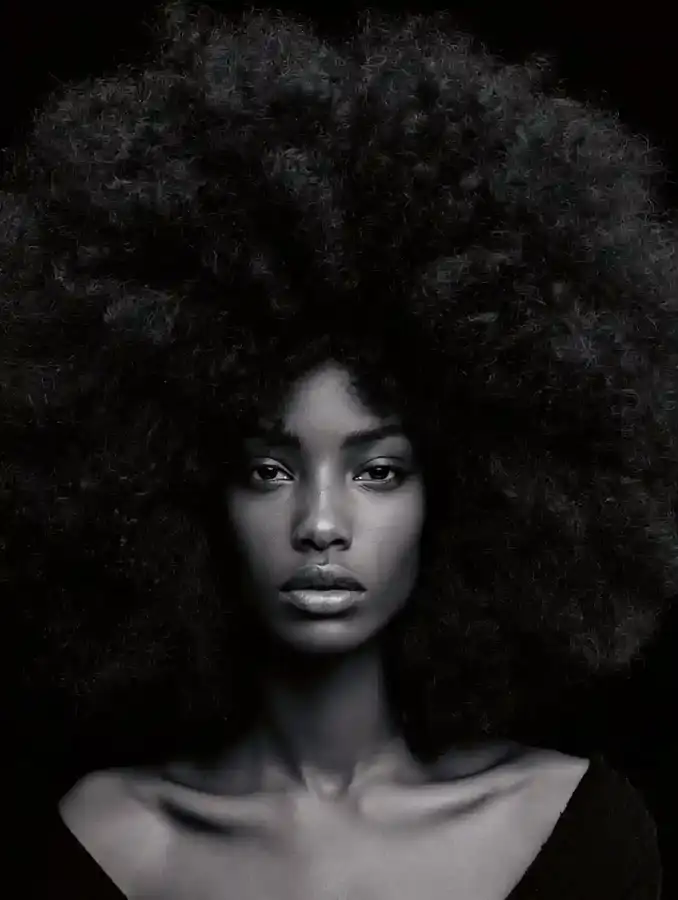 4C coil afro against a soft black backdrop