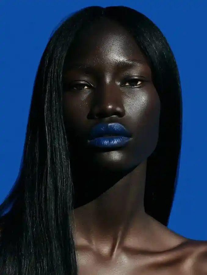 Bone-straight hair against a cobalt blue backdrop