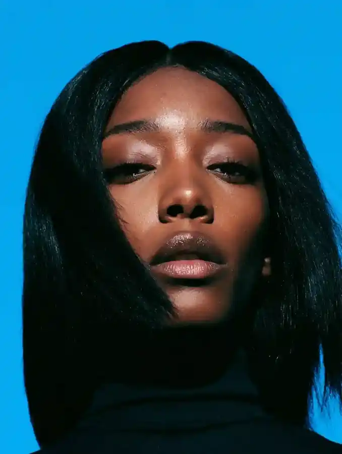 Bone-straight hair against a cobalt blue backdrop