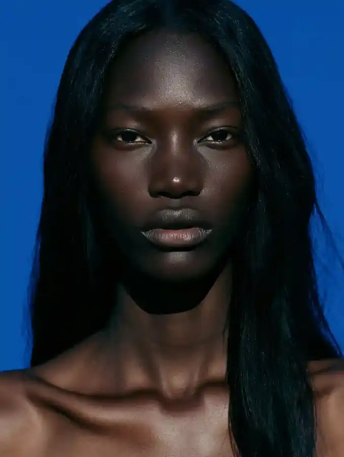 Bone-straight hair against a cobalt blue backdrop