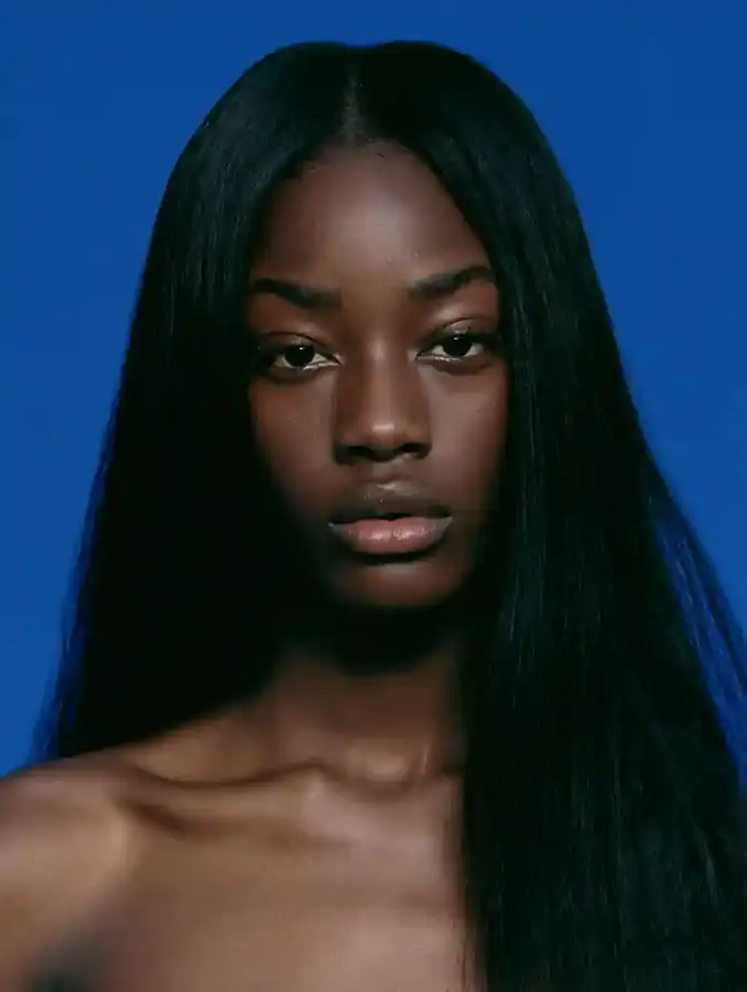 Bone-straight hair against a cobalt blue backdrop