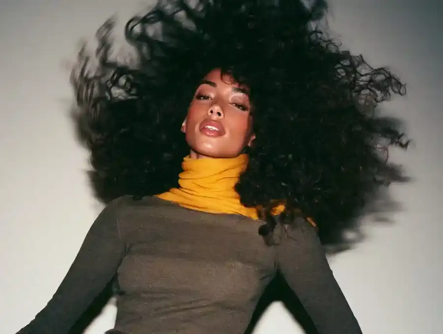 Curly hair being shaken out, mid movement