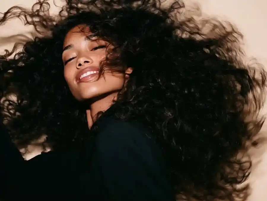Curly hair being shaken out, mid movement