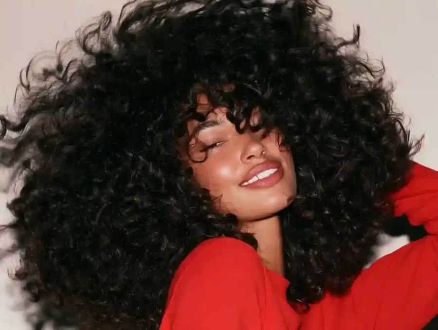 Curly hair being shaken out, mid movement